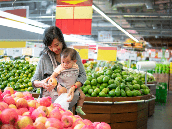 mom buys apples at grocery store