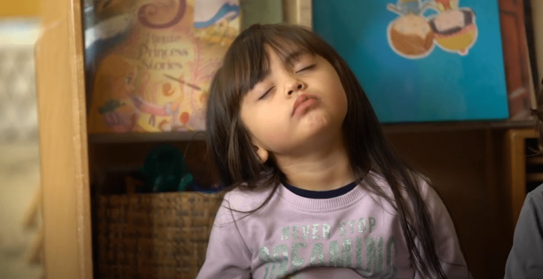 A young girl with closed eyes during a mindfulness practice