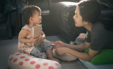 A parent talking to a frustrated toddler