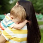 woman holding child in arms