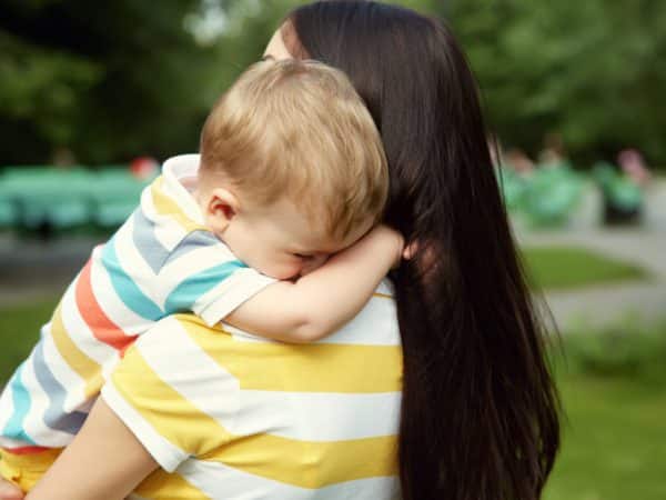 woman holding child in arms