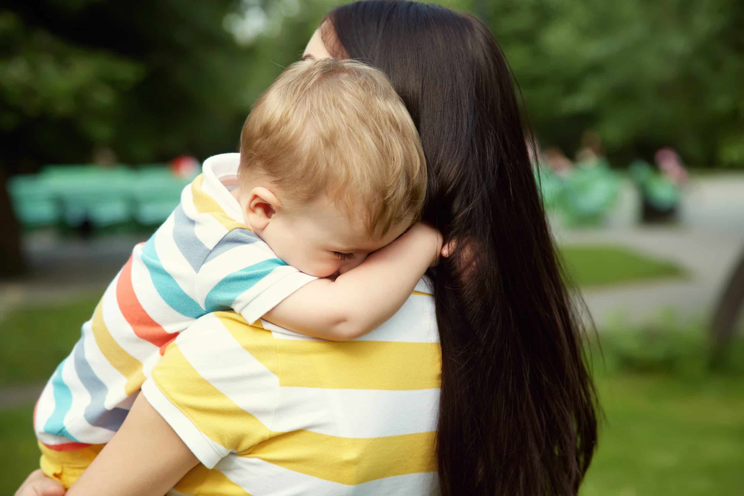 woman holding child in arms