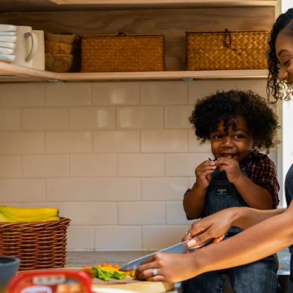 Mom cooks with child, black family