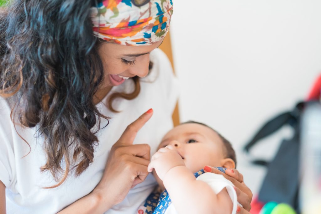 Mom holding infant while looking at them