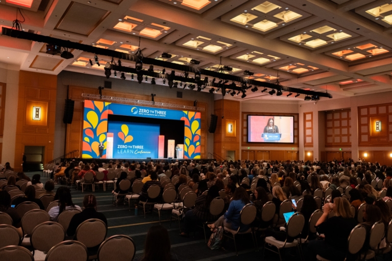 Photo of a large auditorium at early childhood conferences