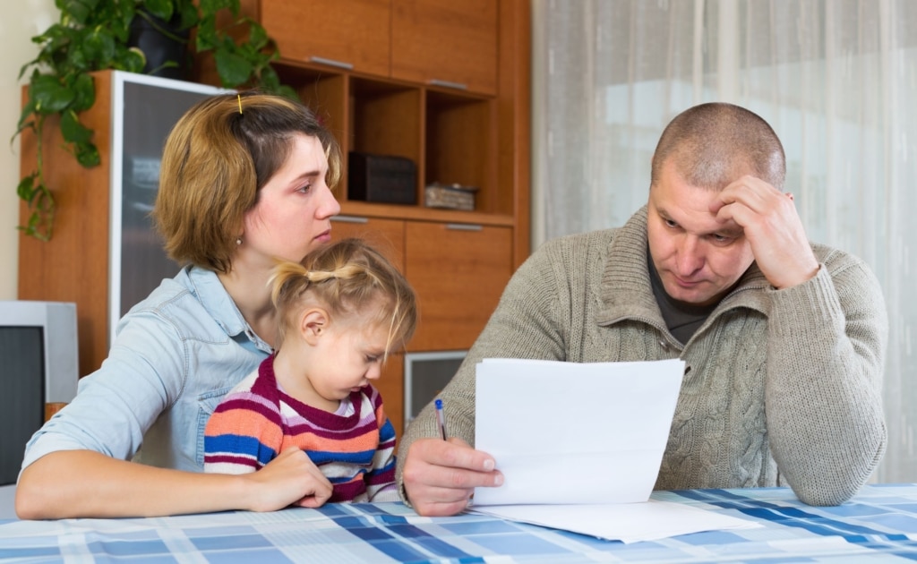 parents looking at a piece of paper with a concerned look