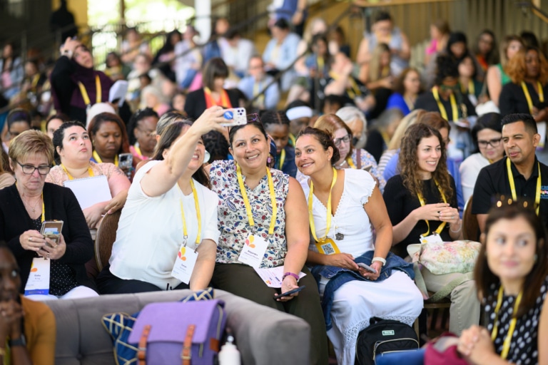 A group of conference attendees taking a photo and smiling