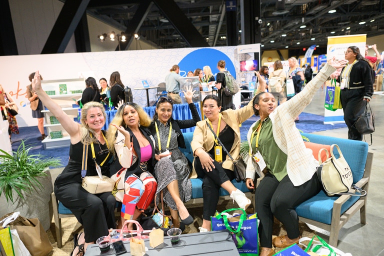 A group of conference attendees sitting together looking excited