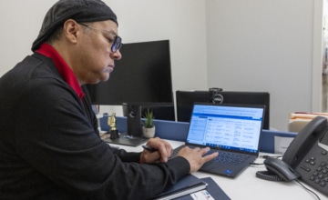 Man sitting at desk using computer