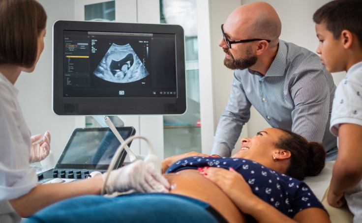 Pregnant woman on utltrasonographic examination at hospital.