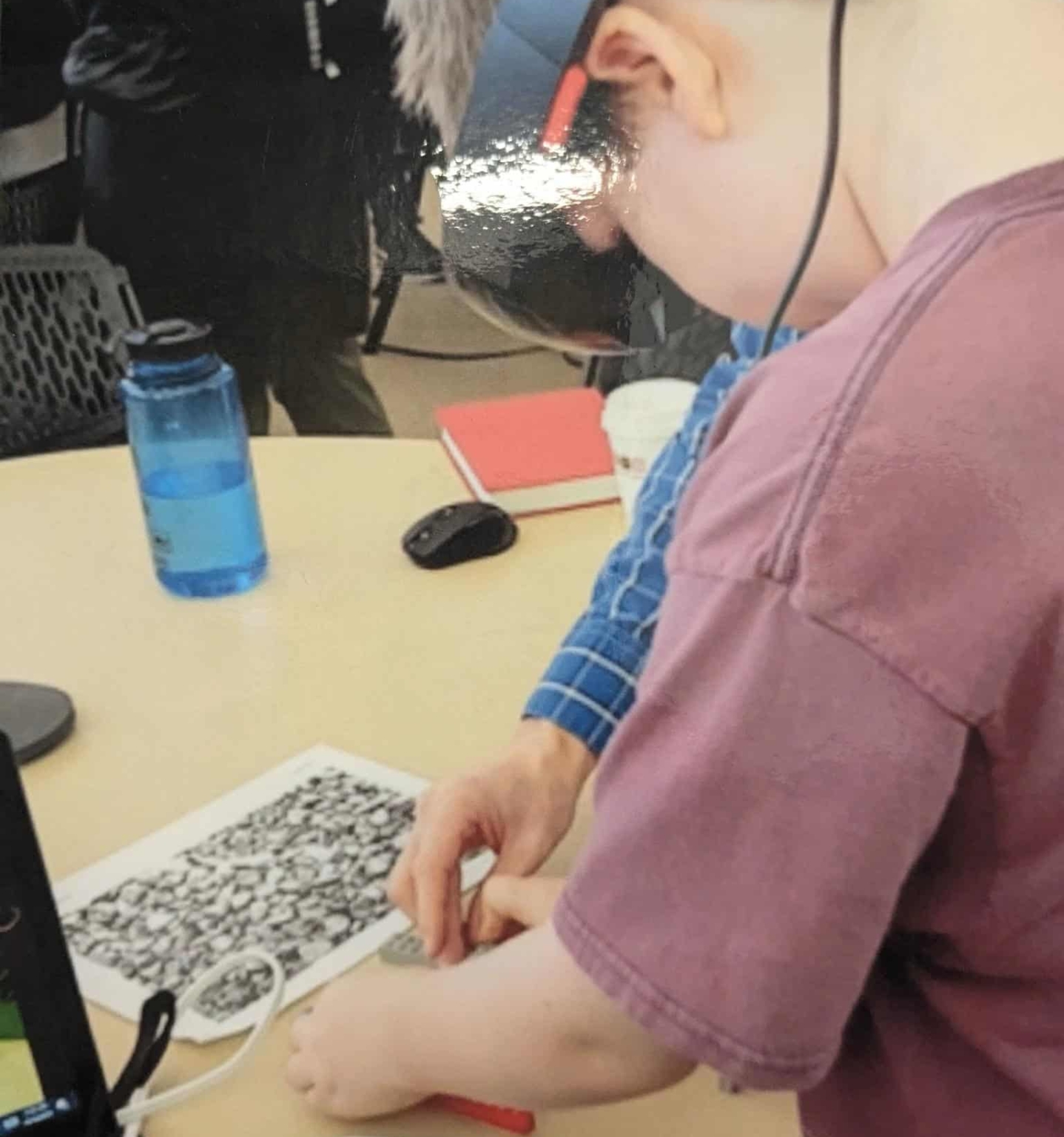 A young boy wearing VR goggles