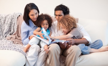 babyfam, love,play,young women,storytelling,book,happy,boys,couch,affecti Young family on the sofa looking at the photo album together