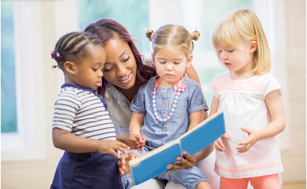 child care worker reading to toddlers