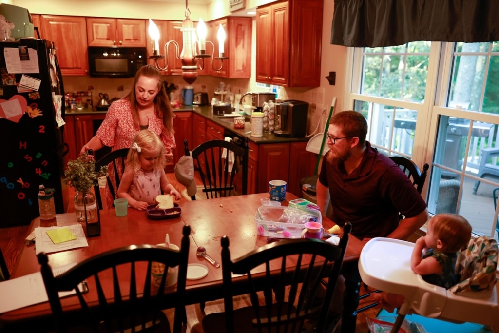 Family at the dinner table with a toddler and a baby